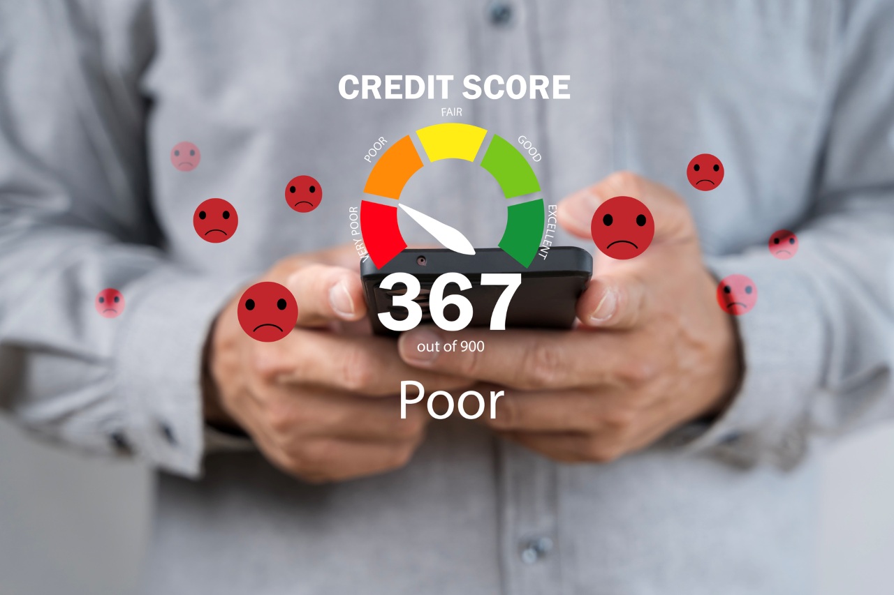 Person holding a smartphone with bad credit score meter on the screen