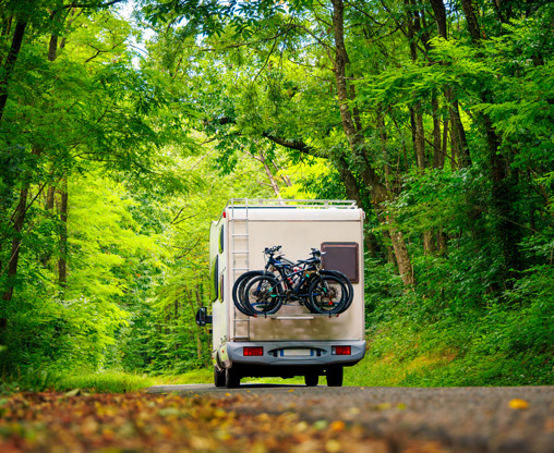 RV-traveling-through-wooded-area