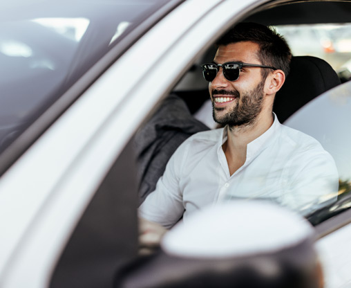 man-driving-white-car