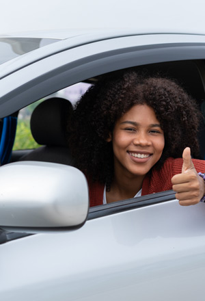 young-driver-giving-a-thumbs-up