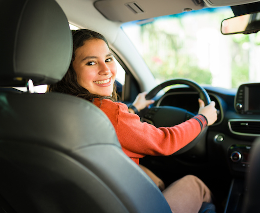 woman in drivers seat looking over shoulder