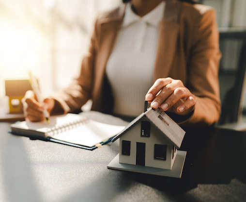 signing-paperwork-with-home-model-on-table.jpg