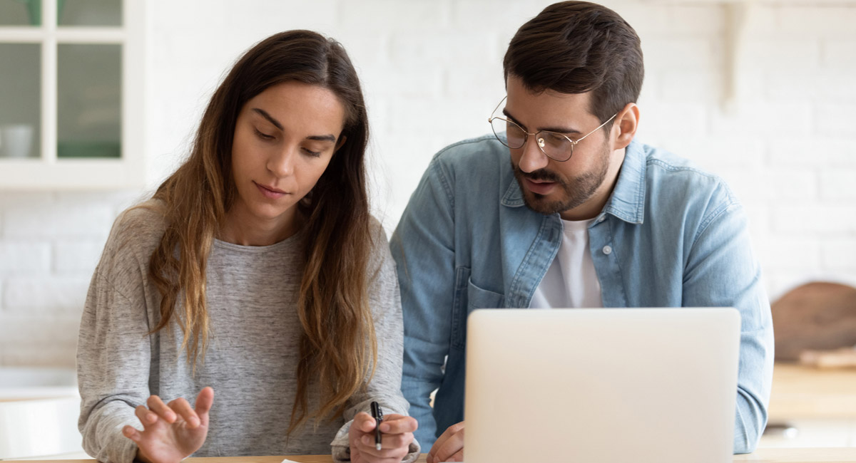 Couple-reviewing-bills-with-laptop-and-calculator