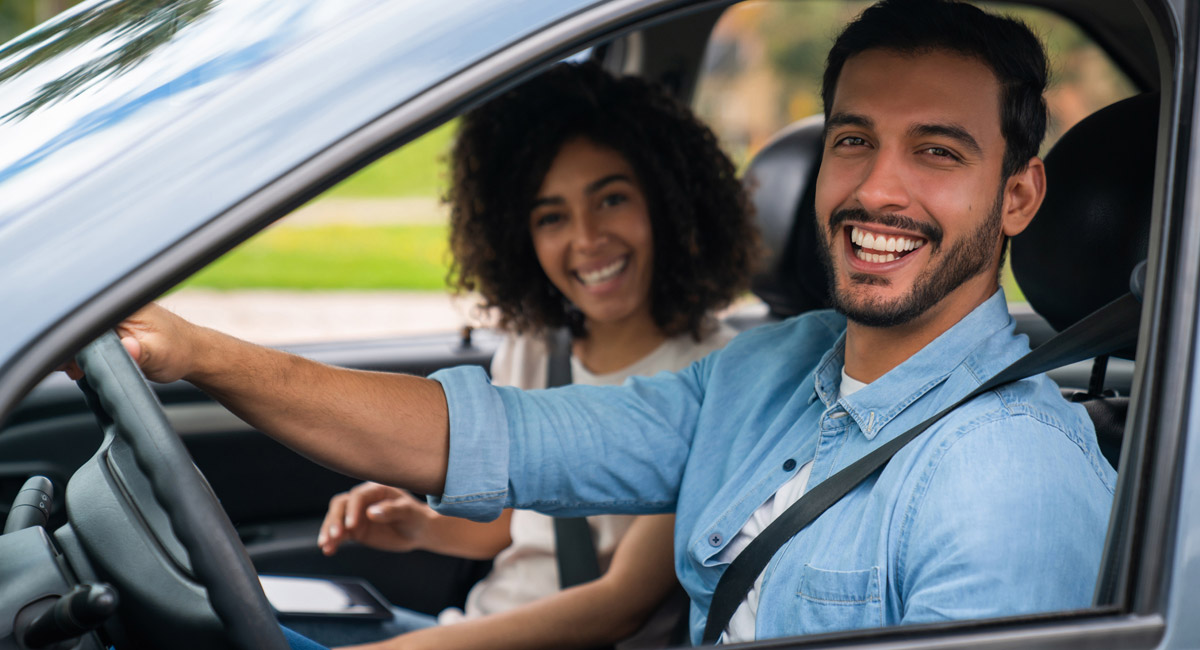 Smiling couple sitting in car