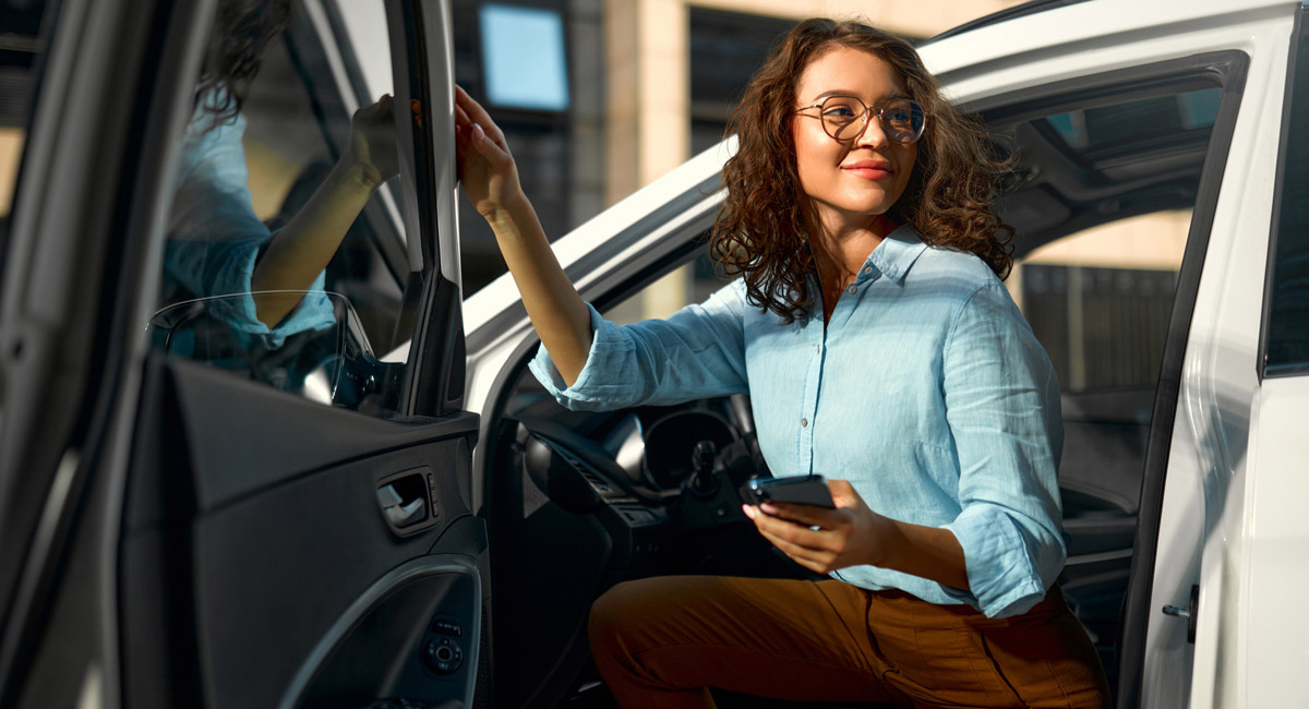 Woman getting into car holding keys