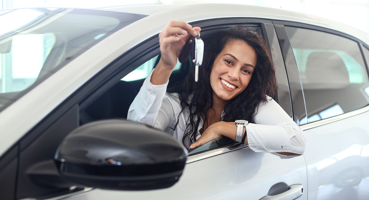 Woman-smiling-in-car-holding-up-keys