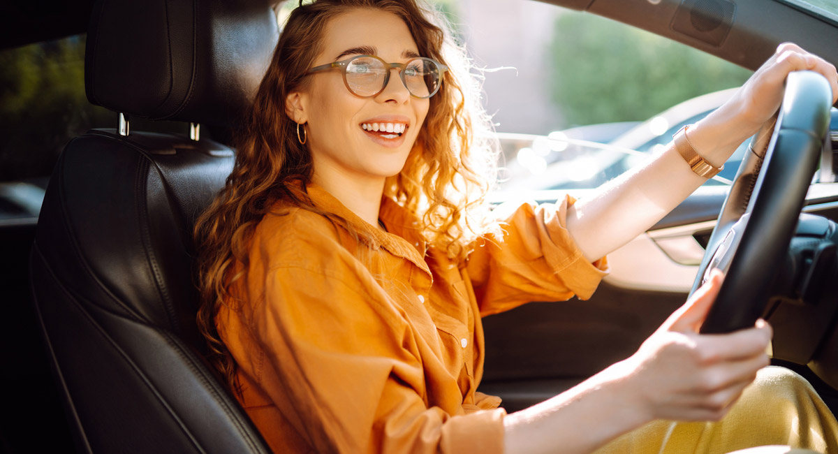 Woman smiling while driving car