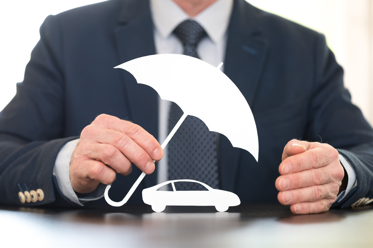 man-in-suit-holding-umbrella-prop-over-car-outline