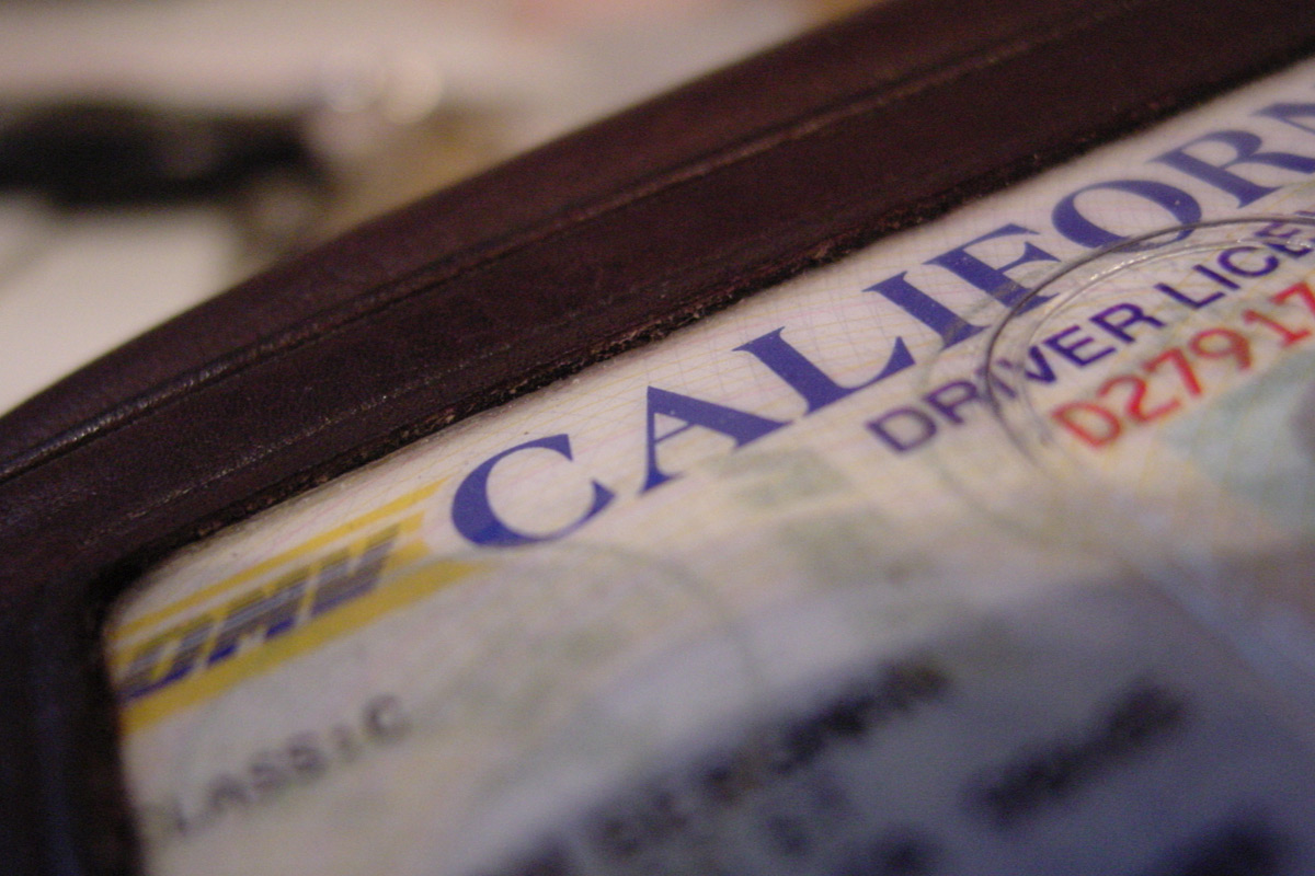 part-of-a-California-driver's-license-visible-in-a-brown-wallet