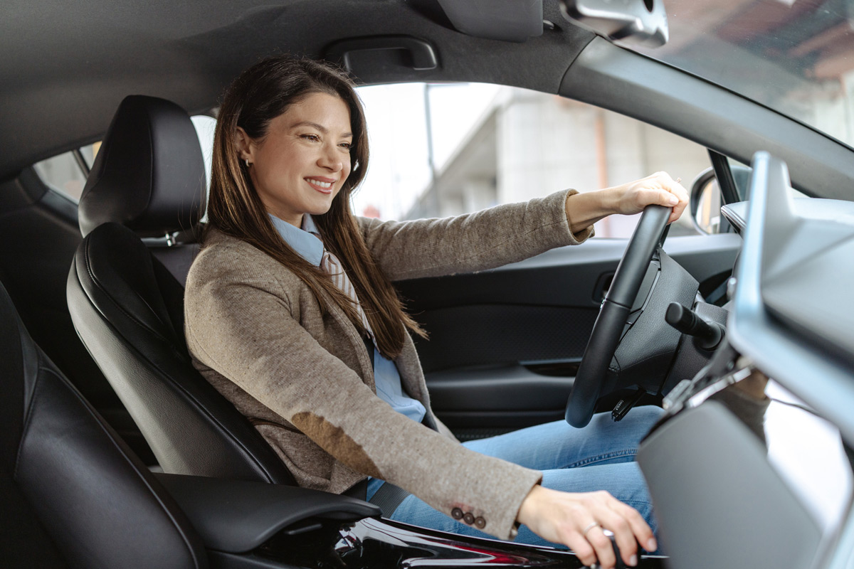 woman-smiling-in-driver's-seat-of-car