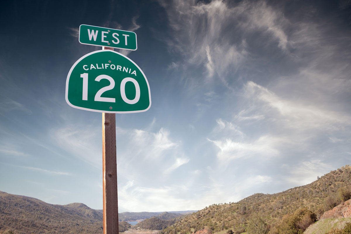 green-sign-for-California-120-West-against-sky