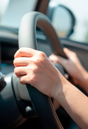 hands-gripping-a-steering-wheel-from-the-driver's-seat