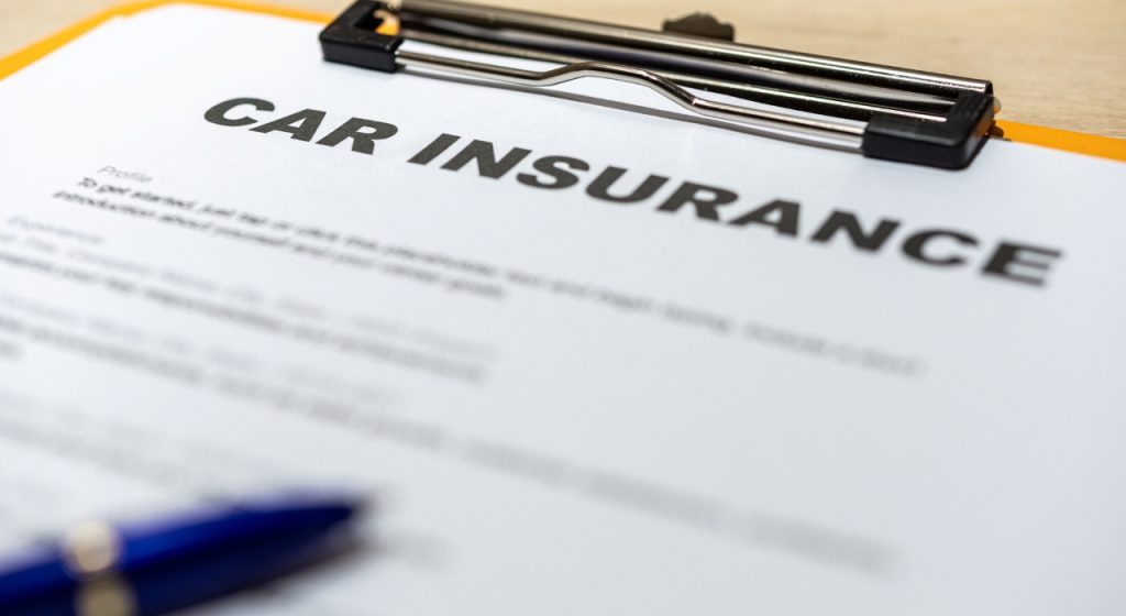 paper on clipboard with words car insurance printed