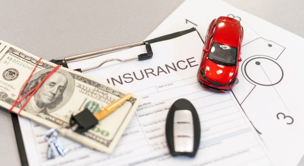car insurance form with money and car keys on top