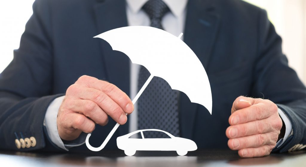 man-in-suit-holding-umbrella-prop-over-car-outline