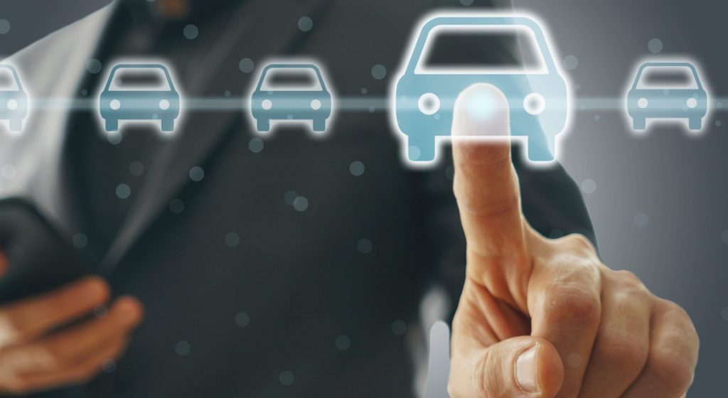 man-pointing-at-digital-illustration-of-cars-while-holding-phone