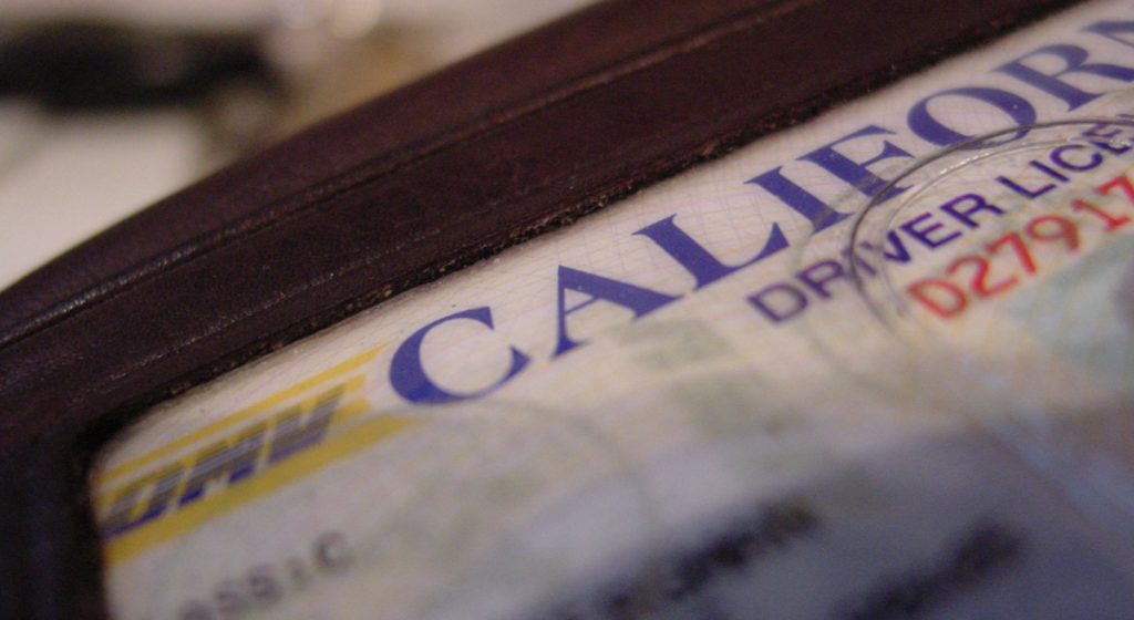part-of-a-California-driver's-license-visible-in-a-brown-wallet
